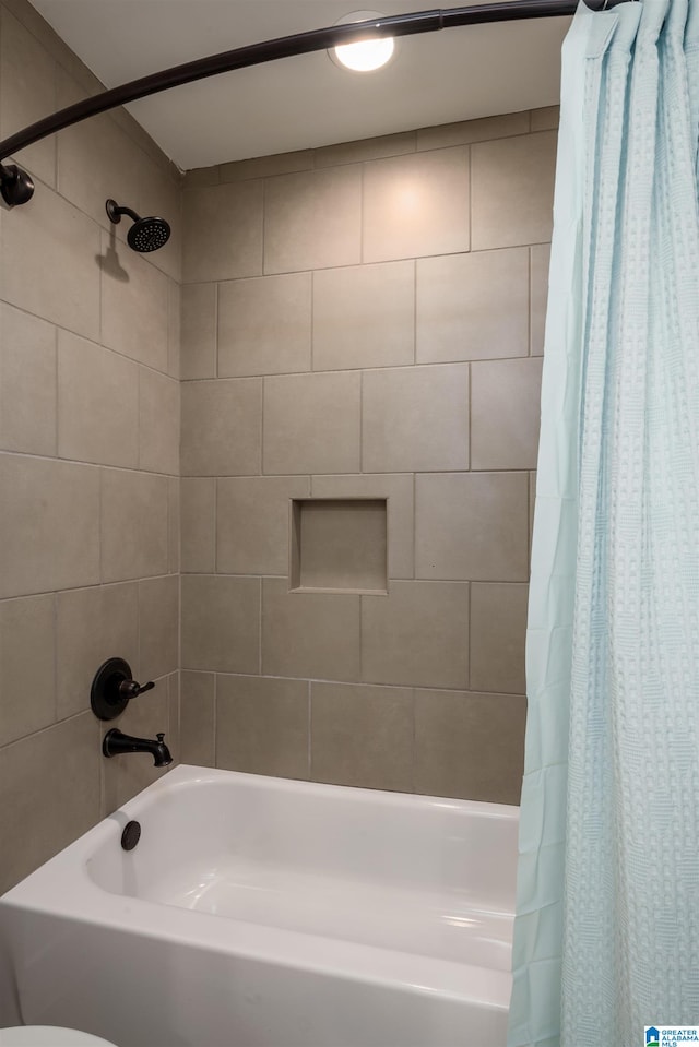 bathroom with shower / bath combination with curtain