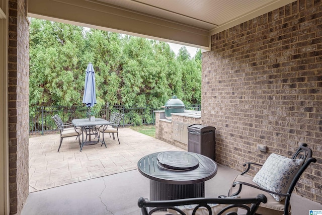 view of patio with area for grilling and a grill