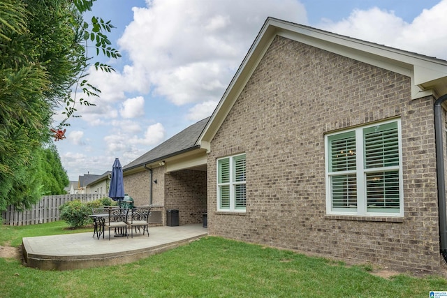 back of house featuring a yard and a patio