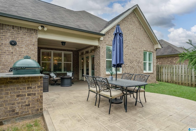 view of patio / terrace with exterior kitchen and a grill