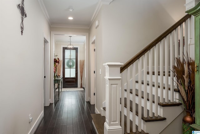 interior space with ornamental molding, a notable chandelier, and dark hardwood / wood-style floors