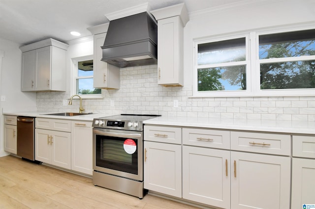 207 Friendship Cir, Clanton, AL 35045 - kitchen featuring light countertops, stainless steel electric range, backsplash, a sink, and custom exhaust hood