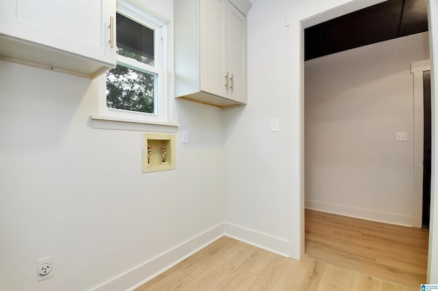 207 Friendship Cir, Clanton, AL 35045 - washroom featuring electric dryer hookup, light wood-type flooring, baseboards, cabinet space, and hookup for a washing machine