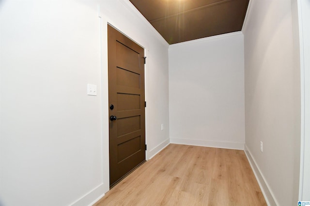 interior space with crown molding and light hardwood / wood-style floors