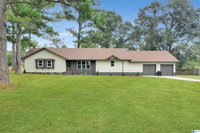 ranch-style house with a garage, fence, concrete driveway, and a front yard