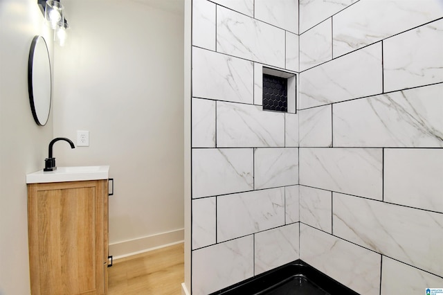 bathroom featuring vanity, wood-type flooring, and walk in shower