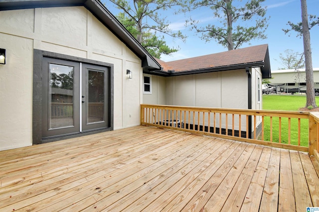 wooden terrace featuring a lawn