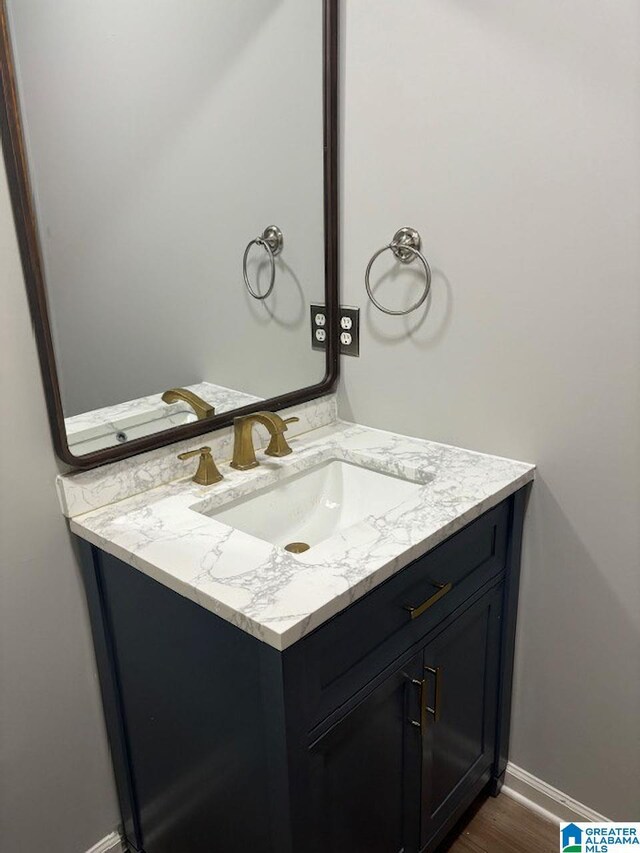 bathroom with vanity and hardwood / wood-style flooring