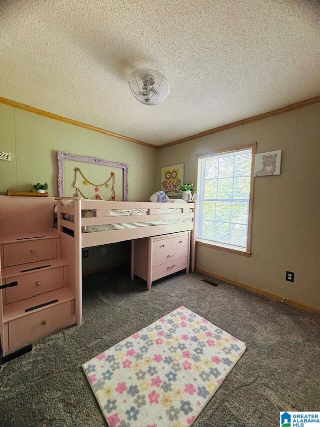 bedroom with a textured ceiling, crown molding, and carpet floors