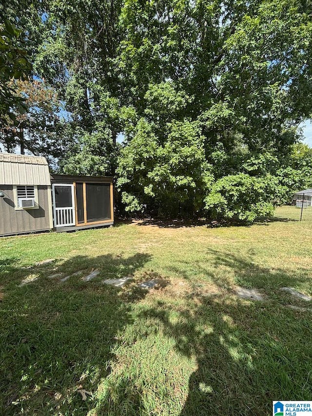 view of yard with cooling unit and a storage unit