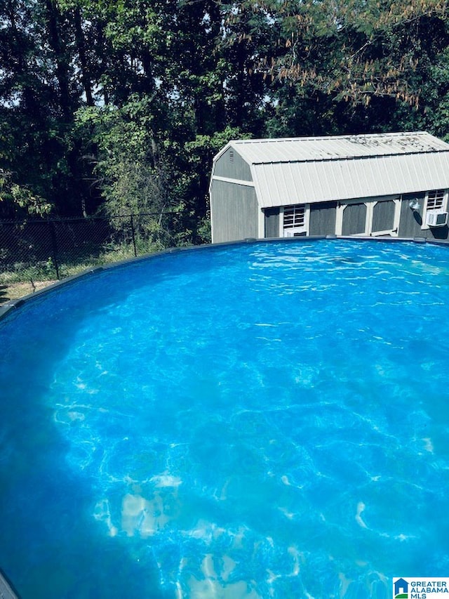 view of pool with an outbuilding