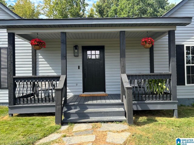 doorway to property with a porch