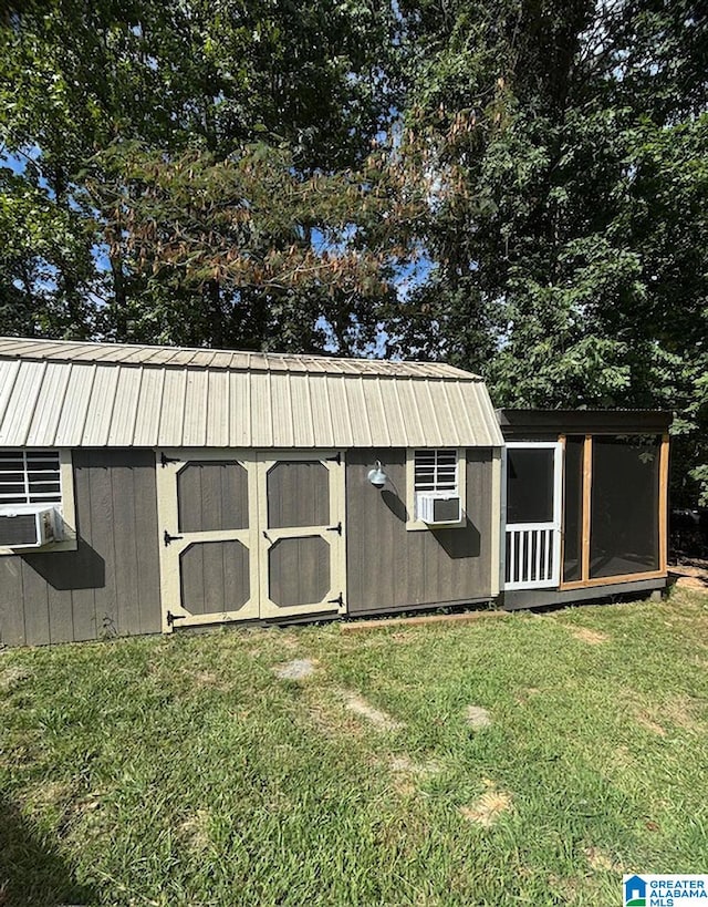 view of outbuilding with cooling unit and a yard