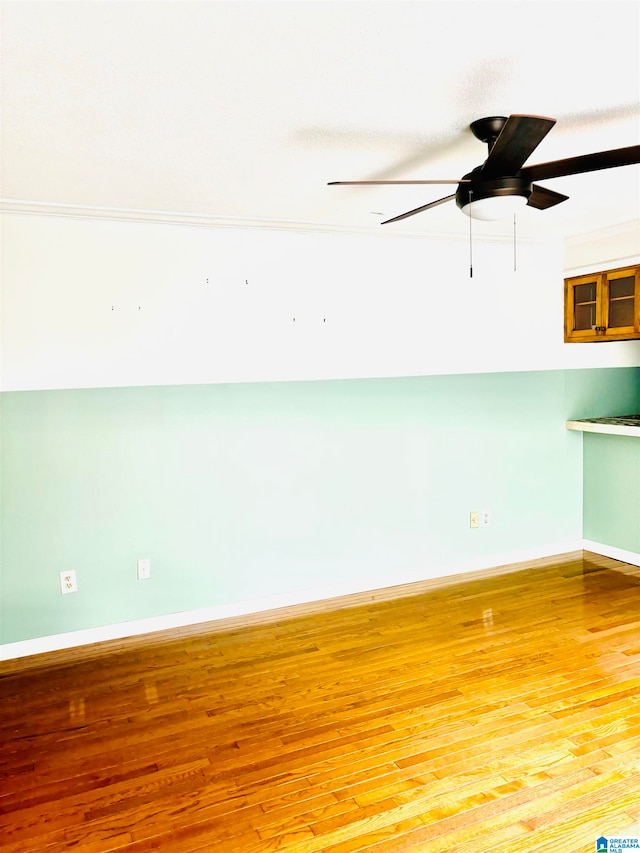 spare room featuring hardwood / wood-style flooring and ceiling fan