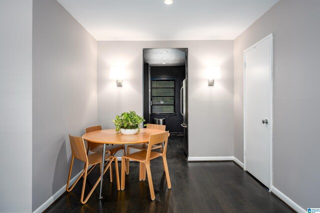 dining space with dark hardwood / wood-style flooring