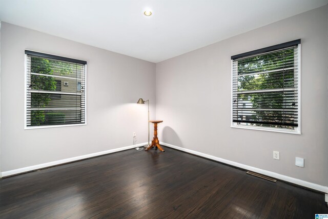 empty room with dark wood-type flooring