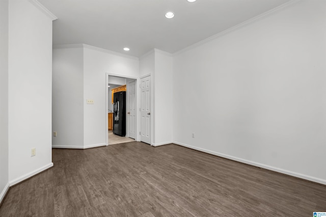 spare room featuring ornamental molding and hardwood / wood-style floors