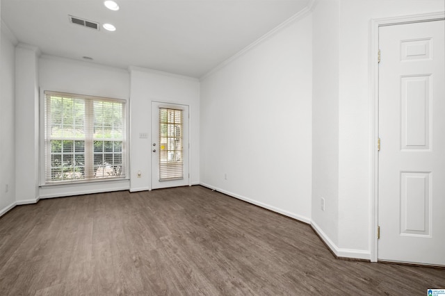 spare room featuring crown molding and dark hardwood / wood-style floors