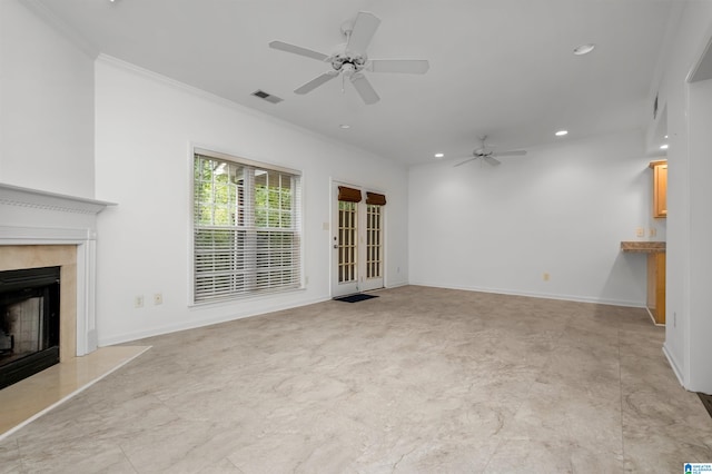 unfurnished living room featuring ceiling fan, crown molding, and a high end fireplace