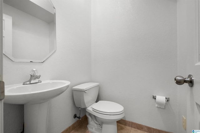 bathroom with toilet and tile patterned flooring