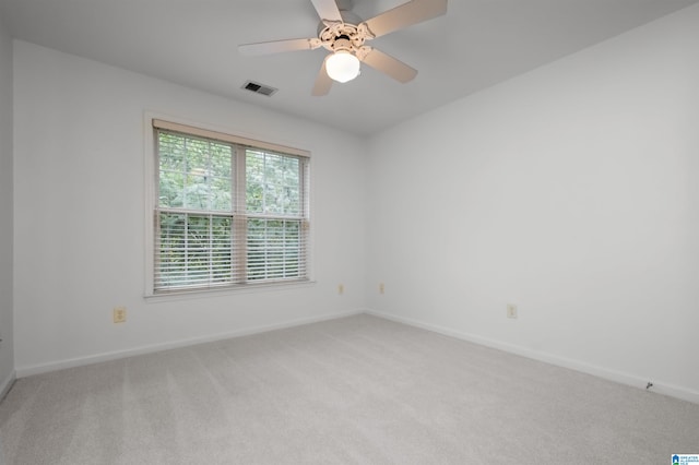 carpeted spare room featuring ceiling fan