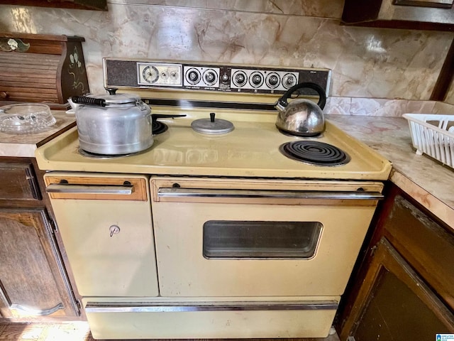 kitchen featuring tasteful backsplash and electric range