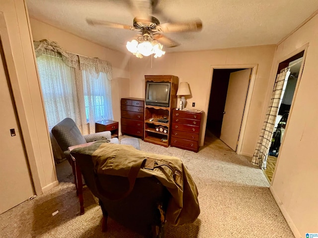 bedroom with a textured ceiling, ceiling fan, and carpet floors