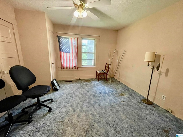 unfurnished room featuring carpet flooring, ceiling fan, and a textured ceiling