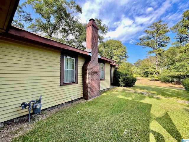 view of side of property with a yard