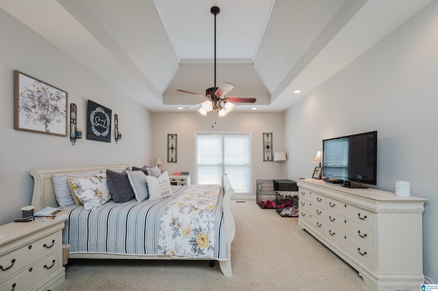 carpeted bedroom with ornamental molding, a raised ceiling, and ceiling fan