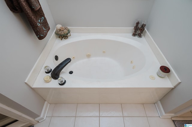 bathroom with a bathtub and tile patterned floors