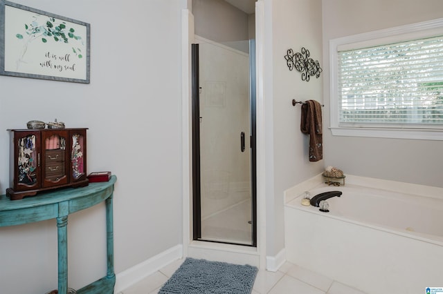 bathroom with tile patterned flooring and separate shower and tub