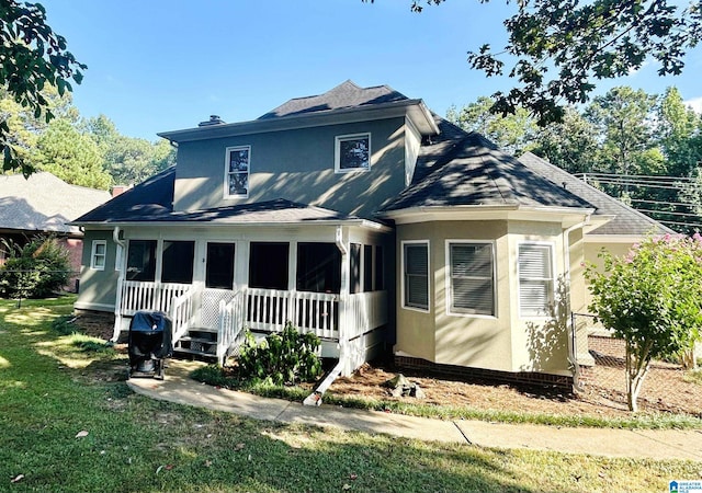 rear view of house with a lawn