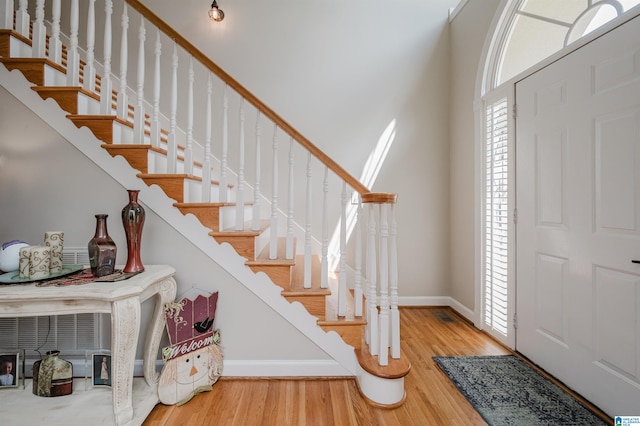 foyer with a fireplace and light hardwood / wood-style flooring