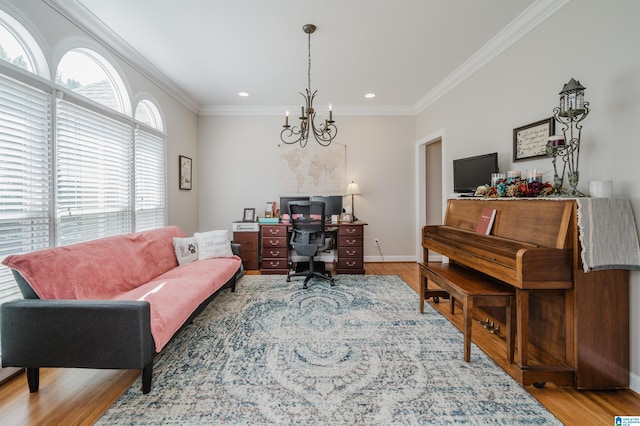 living room featuring wood-type flooring, a chandelier, and ornamental molding