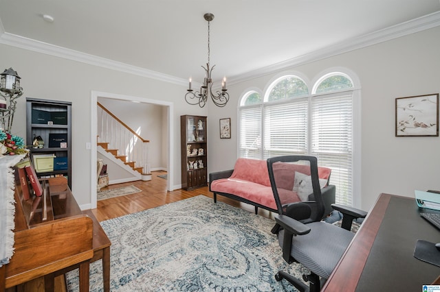 office space featuring light wood-type flooring, ornamental molding, and a notable chandelier