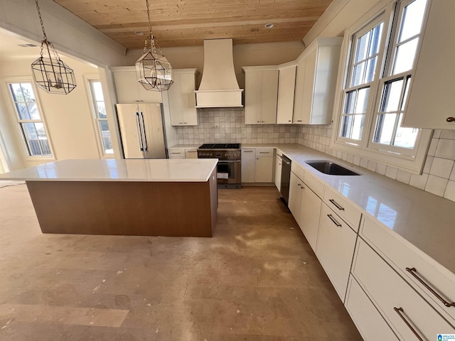 kitchen featuring premium range hood, high quality appliances, white cabinets, and a kitchen island