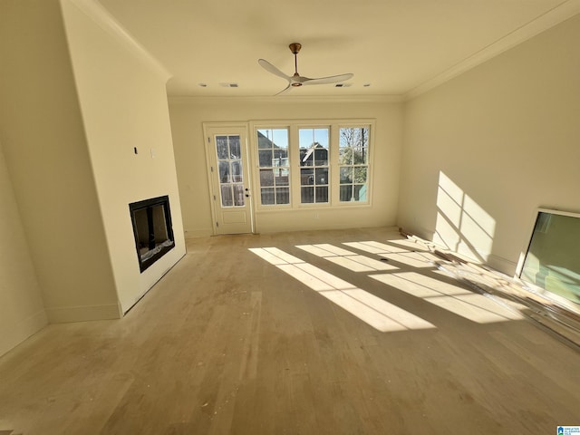 unfurnished living room featuring ceiling fan, crown molding, and light hardwood / wood-style flooring