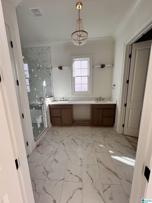 bathroom with a chandelier, vanity, a shower with shower door, and ornamental molding