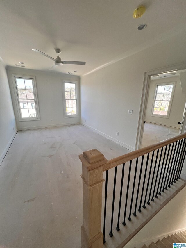 spare room with a wealth of natural light and ceiling fan