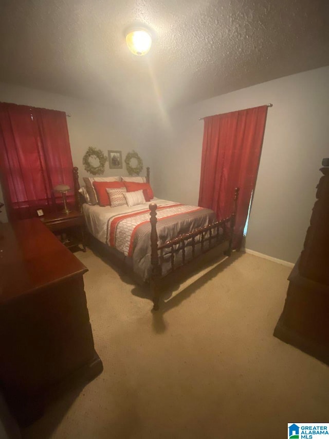 carpeted bedroom featuring a textured ceiling