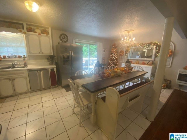 dining room featuring a textured ceiling, heating unit, light tile patterned floors, and an inviting chandelier