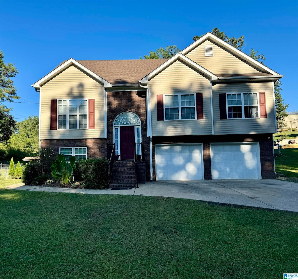 split foyer home with a garage and a front yard