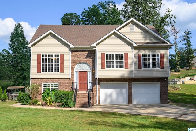 raised ranch with a garage and a front lawn