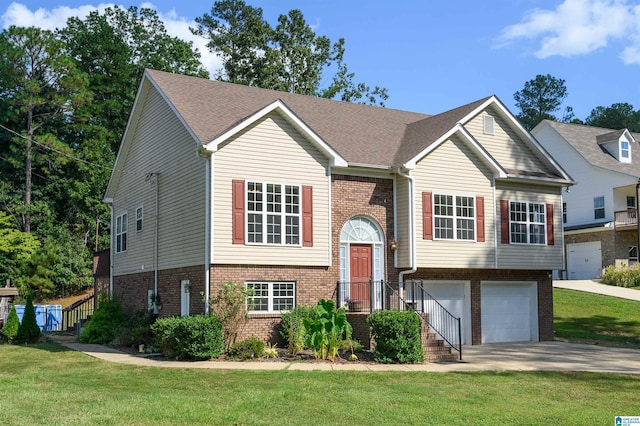 bi-level home with a garage and a front yard