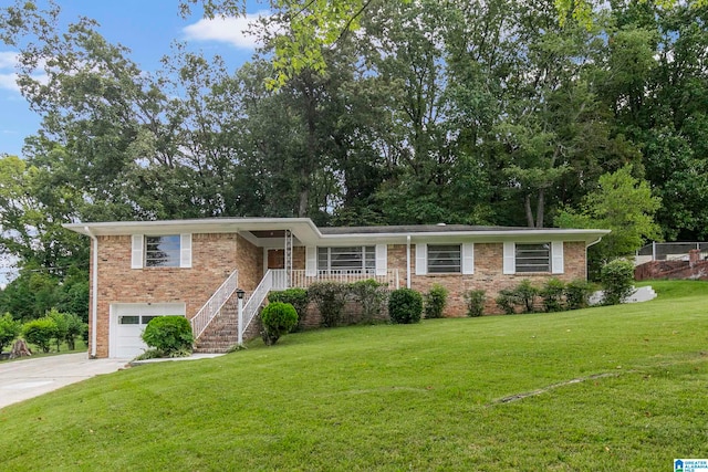 view of front facade with a garage, a front lawn, and covered porch