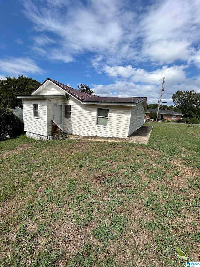 rear view of house with a yard