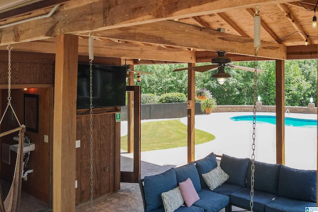 exterior space featuring a gazebo, ceiling fan, a fenced in pool, and an outdoor hangout area