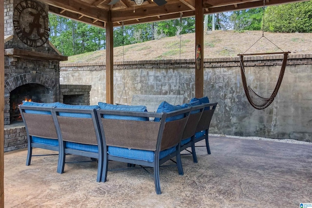 view of patio / terrace featuring an outdoor stone fireplace and a gazebo