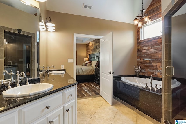 bathroom featuring vanity, independent shower and bath, tile patterned floors, and a chandelier